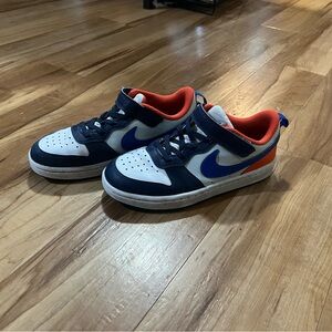 Nike Kids Size 1.5Y Leather Sneakers, White with Blue and Orange Accents.